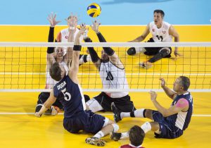 Eric Duda, second from left, of The United States, spikes over the block of Canada's Doug Learoyd, left, and Jesse G. Buckingham, centre, during sitting volleyball semifinal action at the 2015 Parapan Am Games in Toronto on Thursday, August 13, 2015. Canada lost to USA 1-3. THE CANADIAN PRESS/Darren Calabrese